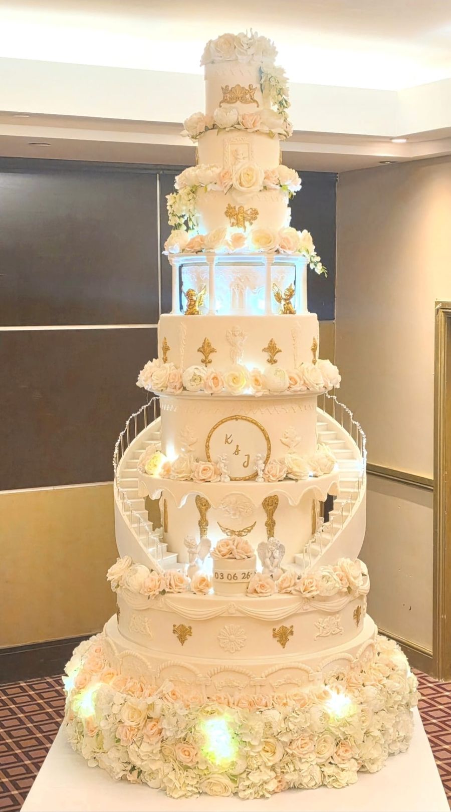 Castle style wedding cake with curved staircases and gold detail