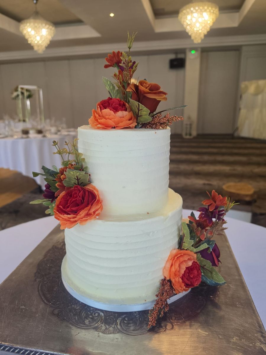 Two tier buttercream cake with autumn flowers