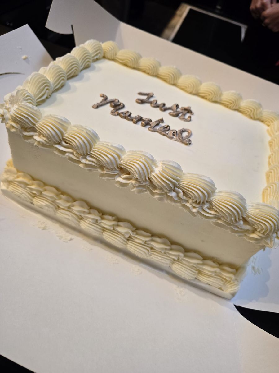 Buttercream sheet cake with gold Just Married script and shell piping