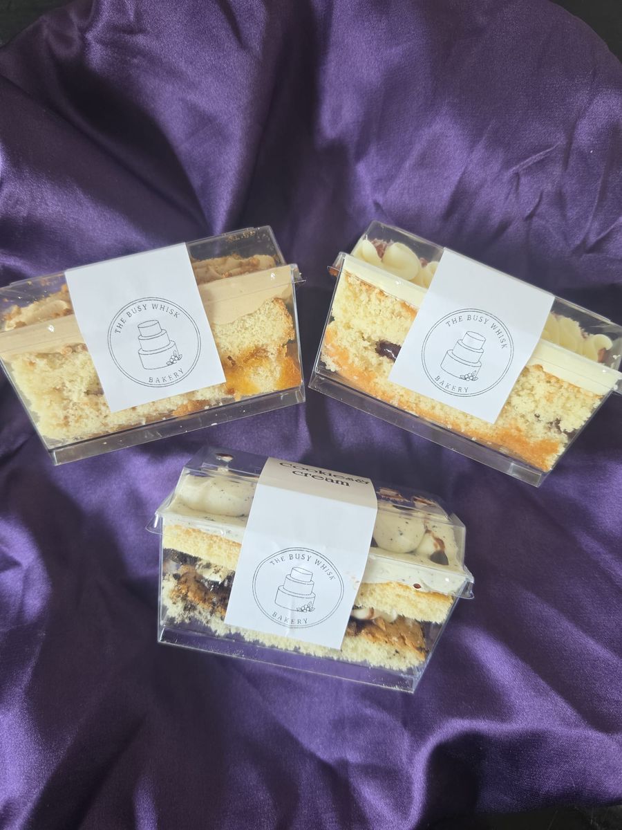Busy Whisk sample pots in branded boxes showing the cake layers